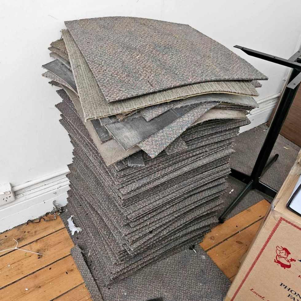 Stacked carpet tiles ready for removal from a Coffs Harbour property