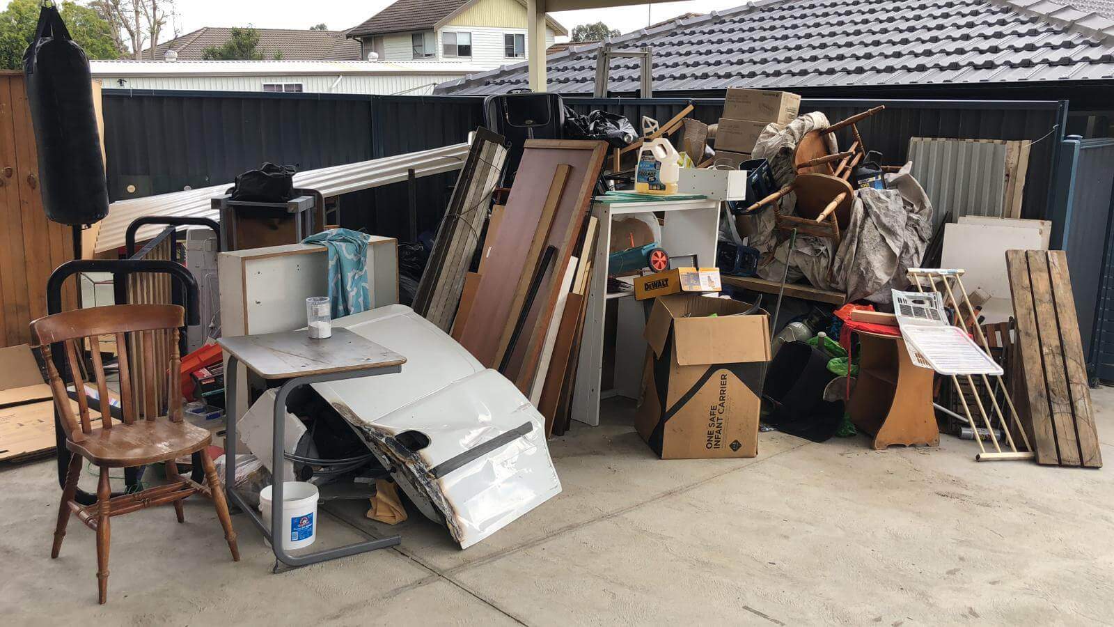 Household junk piled in a backyard ready for removal in Coffs Harbour