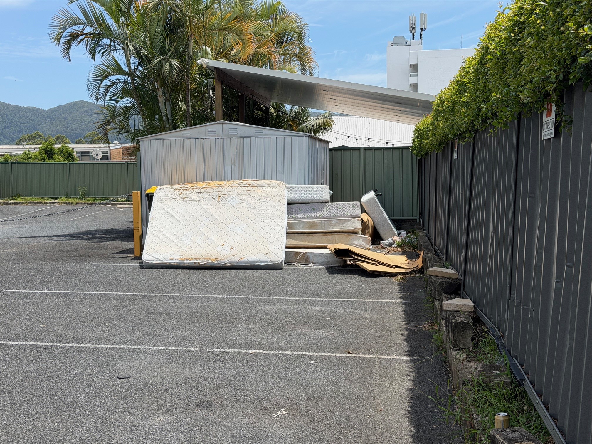 Old mattresses and bed bases left in a Coffs Harbour carpark, ready for mattress removal