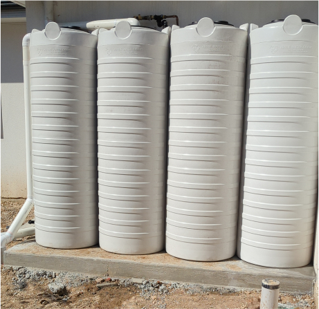 Four white plastic water tanks, examples of plastic tanks we can remove